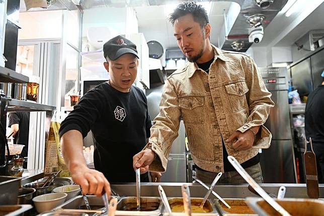 Iao Chi Fai &reg; checks the sauce for cooking at his restaurant in Zhuhai, south China's Guangdong Province, Dec. 13, 2024. (Xinhua/Deng Hua)