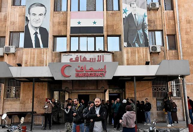 People wait outside a hospital after armed groups fired shells at a dormitory complex in Aleppo city, northern Syria, on Nov. 29, 2024. (Str/Xinhua)