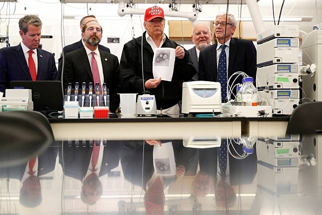 US President Donald Trump holds up an image of the coronavirus during a tour of the Centres for Disease Control in Atlanta, Georgia, on March 6. Photo: Reuters
