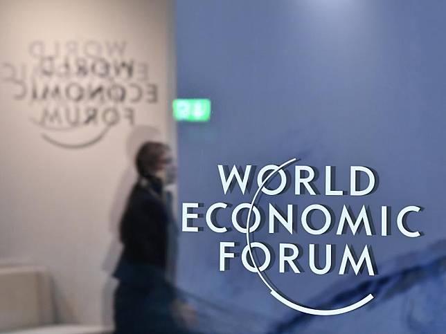 A woman walks past the logo of the World Economic Forum (WEF) in Davos, Switzerland, Jan. 23, 2025. (Xinhua/Lian Yi)