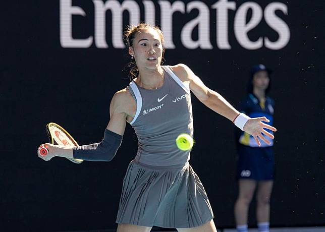 Zheng Qinwen hits a return during an exhibition match against Elina Svitolina of Ukraine at the Australian Open in Melbourne, Australia, on Jan. 8, 2025. (Photo by Chu Chen/Xinhua)