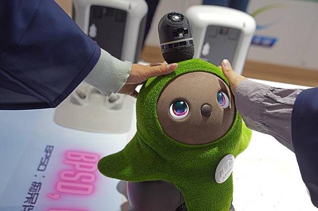 An assistant robot designed for taking care of people who suffer from dementia is seen at the Trade in Services Exhibition Area during the 7th China International Import Expo (CIIE) in east China's Shanghai, Nov. 9, 2024. (Xinhua/Liu Ying)