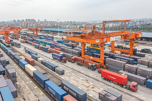 An aerial drone photo taken on July 30, 2024 shows vehicles transferring containers at the Tuanjiecun Station of Chongqing International Logistics Hub Park in Shapingba District of Chongqing, southwest China. (Xinhua/Huang Wei)