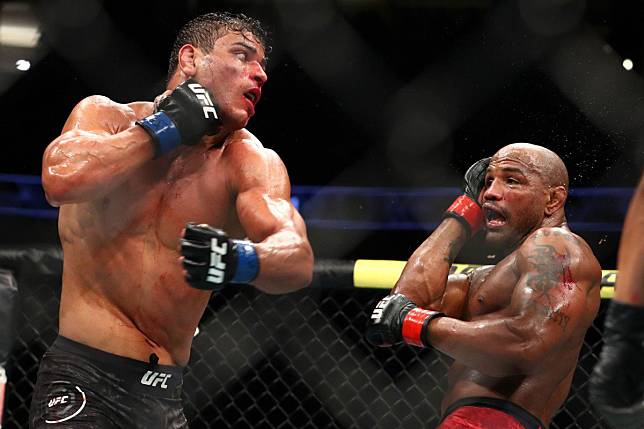 Paulo Costa throws a punch at Yoel Romero at UFC 241. Photo: AFP