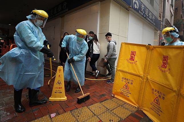 Workers disinfect the pavement outside a location in North Point after another person linked to the Fook Wai Ching She worship hall was confirmed positive for the coronavirus. Photo: Xiaomei Chen