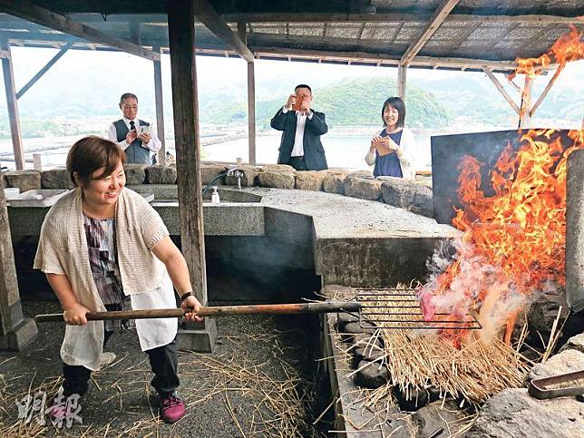 稻草燒起火焰快起快落，可以把鰹魚外層快速烤熟。長長的燒烤架令「廚師」與大火保持距離。（炙烤體驗：400日圓／約29港元）（鄭寶華攝）