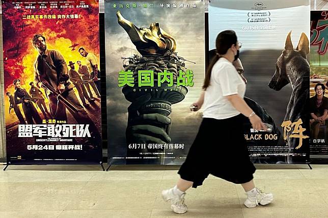 This photo shows a woman walking past a poster of the U.S. movie &ldquo;Civil War&rdquo; at a cinema in Beijing, June 7, 2024. (Xinhua/Shen Anni)
