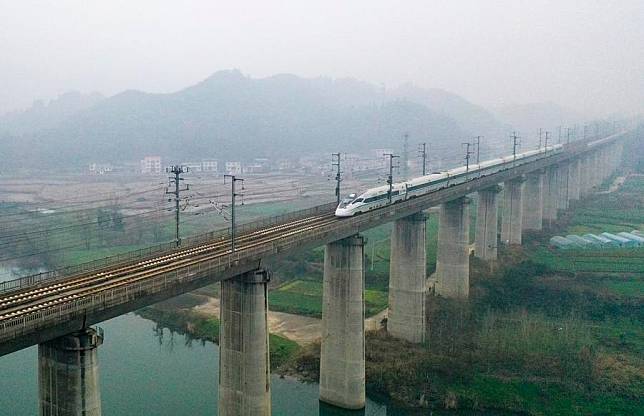 This aerial photo taken on Jan. 9, 2024 shows a high-speed train running on a bridge in Yuping Dong Autonomous County of Tongren City, southwest China's Guizhou Province. (Photo by Hu Panxue/Xinhua)