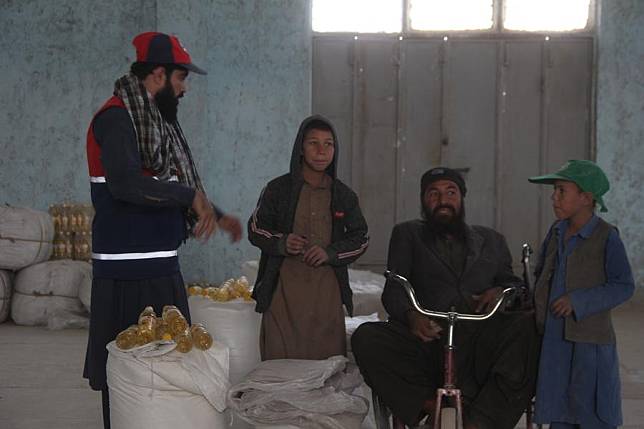 People receive China-donated humanitarian assistance in Nimroz province, Afghanistan, on Oct. 28, 2024. (Photo by AzizXinhua)