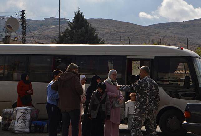 Lebanese refugees return from Syria to Lebanon via the Masnaa border crossing on Nov. 29, 2024. (Photo by Taher Abu Hamdan/Xinhua)