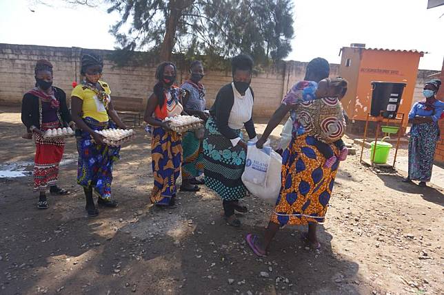 Beneficiaries of the food supplement program run by the Women's Federation for World Peace in Zambia hold received rations at a health facility in Lusaka, Zambia, on July 23, 2021. (Photo by Lillian Banda/Xinhua)