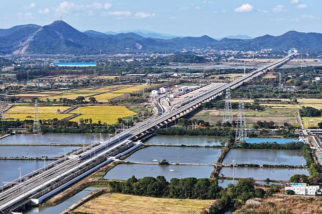 An aerial drone photo taken in Huzhou, east China's Zhejiang Province on Nov. 23, 2024 shows the bullet train No. G55505 running on a new high-speed rail line connecting Shanghai Municipality with the provinces of Jiangsu and Zhejiang in east China. (Photo by He Weiwei/Xinhua)