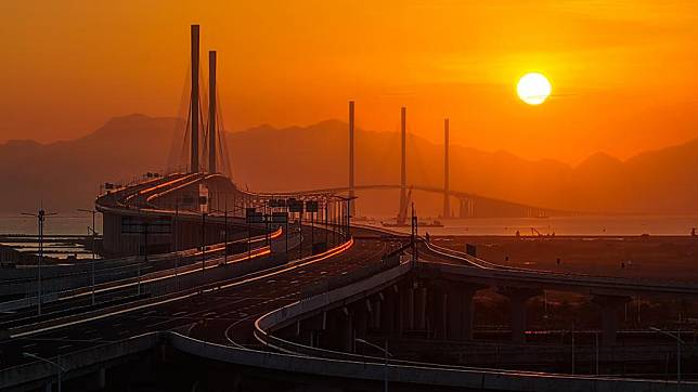 An aerial drone photo taken on Dec. 4, 2024 shows a view of Gaolan Port Bridge (with twin main towers on the left) and Huangmaohai Bridge (with three main towers on the right) in south China's Guangdong Province. The Huangmaohai Cross-Sea Passage, linking Guangdong's Zhuhai City and Jiangmen City, was officially opened to traffic on Wednesday. (Xinhua/Liu Dawei)