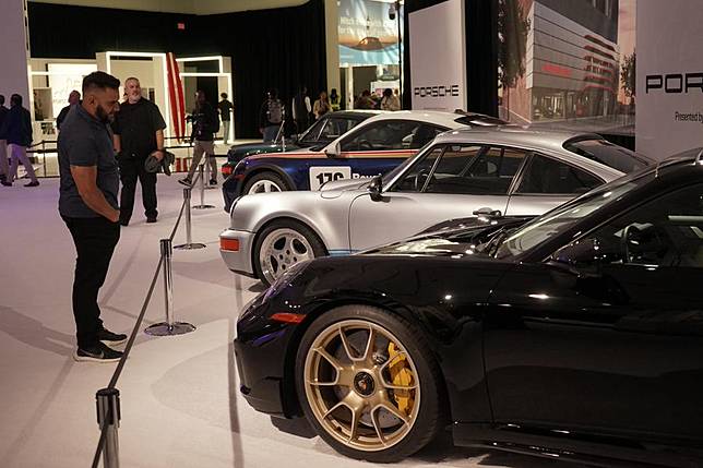 People look at vehicles during a media preview of the 2024 Los Angeles Auto Show in Los Angeles, California, the United States, on Nov. 21, 2024. (Photo by Zeng Hui/Xinhua)