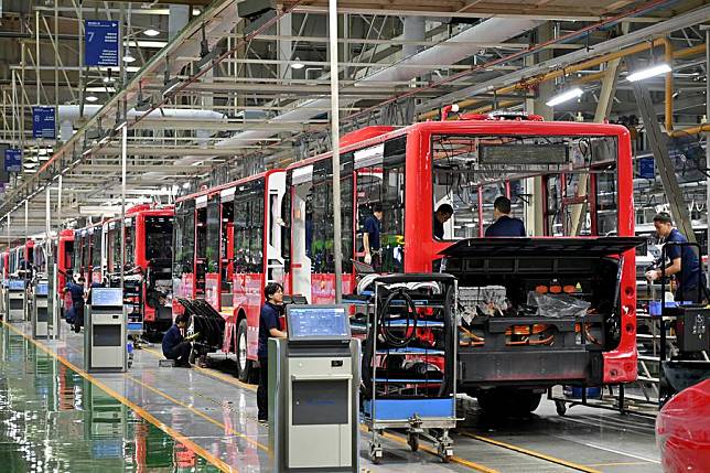 Staff members work on an assembling line in the new energy vehicle factory of Zhengzhou Yutong Bus Co., Ltd. in Zhengzhou, central China's Henan Province, July 29, 2024. (Xinhua/Li Xin)