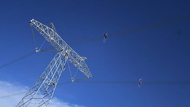 Workers conduct routing inspection of power transmission lines at Tanggulashan Township of Golmud City in the Mongolian-Tibetan Autonomous Prefecture of Haixi, northwest China's Qinghai Province, June 3, 2023. (Photo by Pan Binbin/Xinhua)