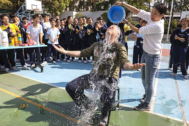 Schoolteacher Brian Bittner does the bucket challenge at the Shung Tak Catholic English College fundraising fair for Operation Santa Claus in Yuen Long. The school won the Most Creative School Fundraiser award. Photo: Dickson Lee