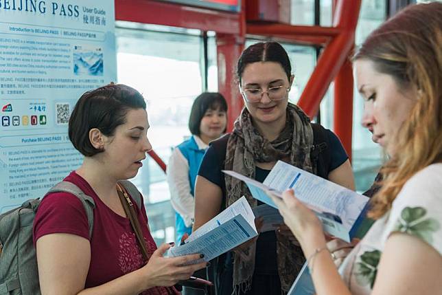 International visitors read manuals for Beijing Pass at Beijing Capital International Airport in Beijing, capital of China, July 31, 2024. (Xinhua)