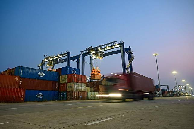 Containers are transported at Yangpu International Container Port in the Yangpu Economic Development Zone in Danzhou, south China's Hainan Province, Jan. 9, 2025. (Xinhua/Pu Xiaoxu)