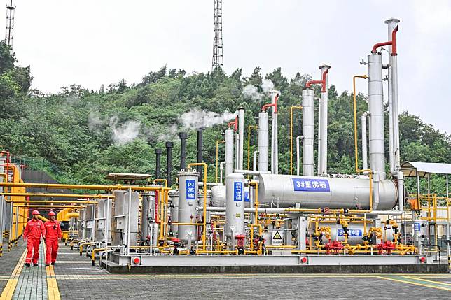 Technicians check equipment at a gas gathering and transmission station of the Fuling shale gas field in Fuling, southwest China's Chongqing, Sept. 21, 2023. (Xinhua/Wang Quanchao)