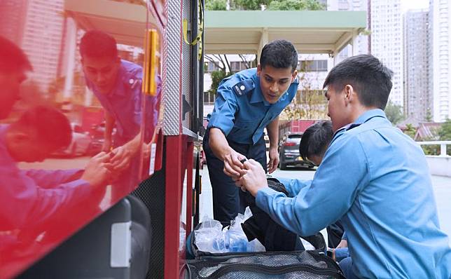 Mohammad Shakir (L), a firefighter of Pakistani descent, conducts a routine check on a fire truck with his colleague in Hong Kong, south China, on Oct. 28, 2024. (Xinhua/Chen Duo)