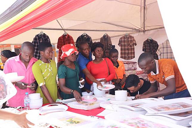 Local customers buy home supplies from a stall at the Sino-Uganda Mbale Industrial Park trade expo in Mbale, Uganda, on Oct. 18, 2024. (Xinhua/Nie Zuguo)