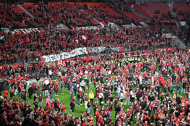 Fans of Bayer Leverkusen celebrate after the Bundesliga match between Bayer Leverkusen and SV Werder Bremen in Leverkusen, Germany, April 14, 2024. (Photo by Ulrich Hufnagel/Xinhua)