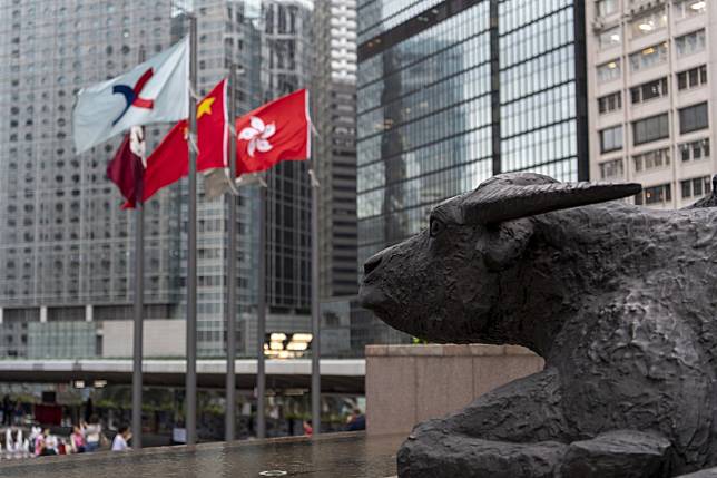Bronze sculptures of bulls, the symbol of the Hong Kong stock exchange, at the Exchange Square in Central, Hong Kong. Photo: Warton Li