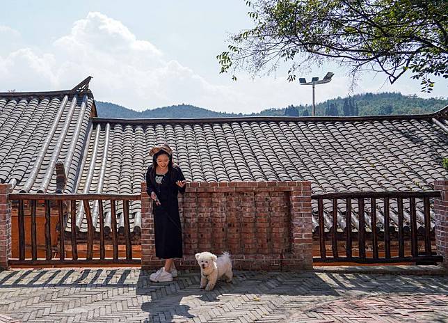 A sojourner walks a dog at Tuguachong Village, Qujing City, southwest China's Yunnan Province, Oct. 30, 2024. (Xinhua/Wang Jingyi)