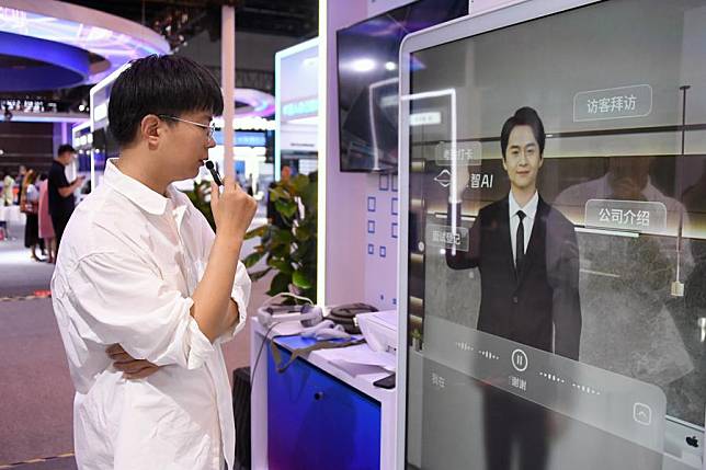 A staff member demonstrates his interaction with a virtual human during the Global Digital Economy Conference 2024 (GDEC 2024) in Beijing, capital of China, July 2, 2024. (Xinhua/Ren Chao)