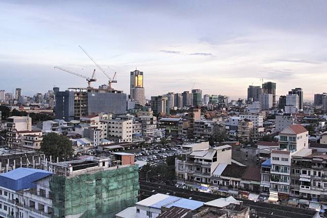 Phnom Penh at dusk, looking southeast from the old French quarter to the Chamkarmon district. A rash of high-rise construction has changed the cityscape in the past 15 years, and many heritage buildings have been lost. Photo: Huw Watkin