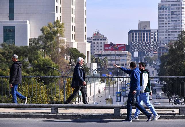 People walk on a street in Damascus, Syria, Dec. 10, 2024. (Photo by Ammar Safarjalani/Xinhua)