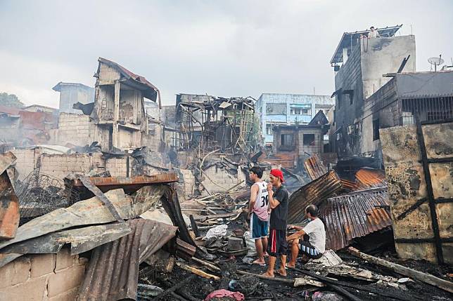 Residents return to their charred homes after a fire at a slum area in Manila, the Philippines, on Oct. 15, 2024. (Xinhua/Rouelle Umali)