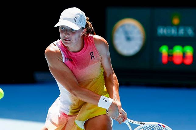 Iga Swiatek of Poland hits a return during the women's singles quarterfinals match against Emma Navarro of the United States at Australian Open tennis tournament in Melbourne, Australia, Jan. 22, 2025. (Photo by Chu Chen/Xinhua)