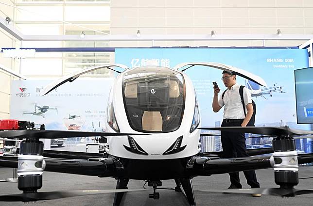 A visitor looks at an aircraft at the low-altitude economy exhibition area at the World Intelligence Expo 2024 in north China's Tianjin, June 20, 2024. (Xinhua/Zhao Zishuo)
