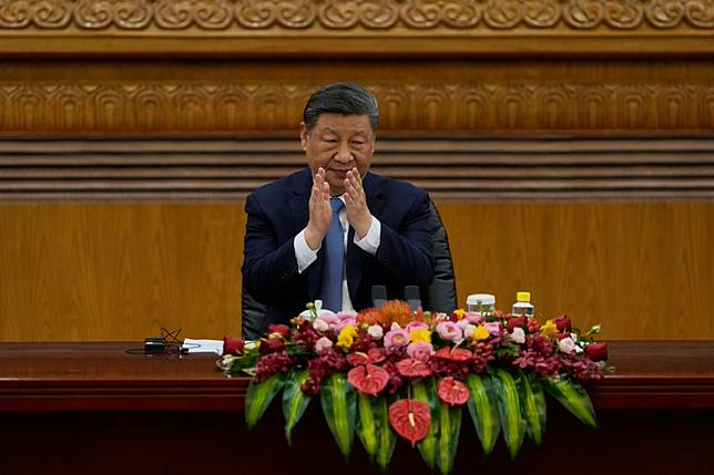 圖為習近平3月28日在北京人民大會堂會見國際商界代表。（美聯社）