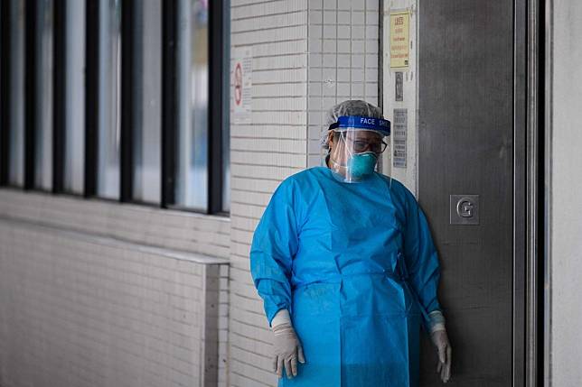 A medical worker wearing protective gear stands outside a lift at Hong Kong’s Princess Margaret Hospital on February 4. Photo: AFP