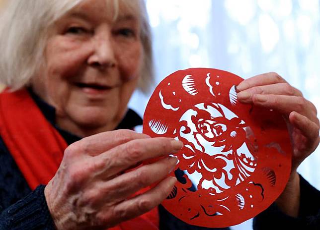 British sinologist Frances Wood shows a paper-cutting work during the &ldquo;Intangible Cultural Heritage Yaji&rdquo; event in London, Britain, Jan. 23, 2025. (Xinhua/Li Ying)