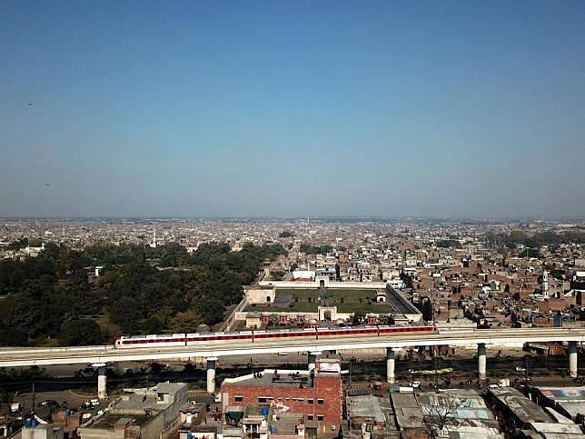 An aerial drone photo taken on Feb. 2, 2024 shows an Orange Line Metro Train (OLMT) running on the track in Lahore, Pakistan. (Xinhua/Ahmad Kamal)