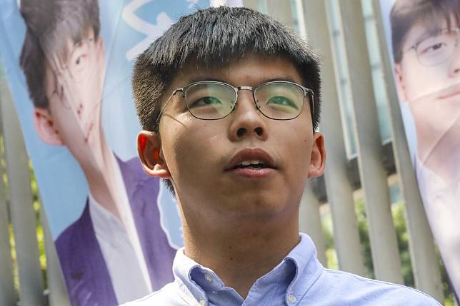 Pro-democracy activist Joshua Wong, who has received a letter from returning officers seeking explanation of his stance, says he will not let his rival win uncontested. Photo: K.Y. Cheng