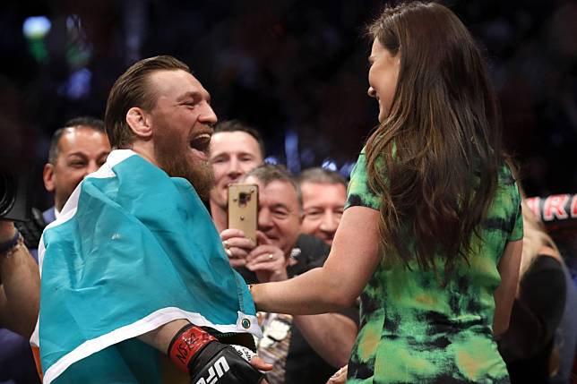 Conor McGregor celebrates with girlfriend Dee Devlin after defeating Donald Cerrone at UFC 246. Photo: AFP