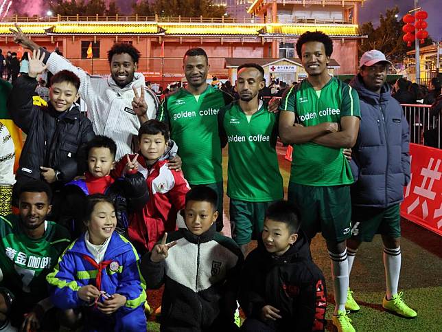 Football lovers from Ethiopia take a group photo with spectators after the competition in Rongjiang County, southwest China's Guizhou Province, Dec. 31, 2024. (Xinhua/Luo Yu)