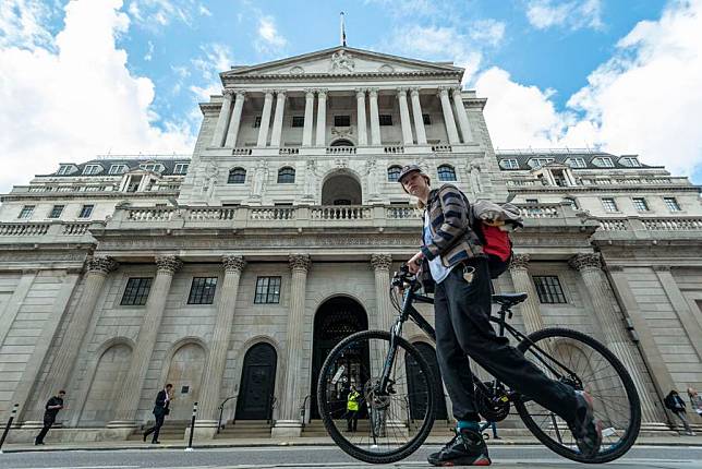 A woman walks past the Bank of England in London, Britain, on April 13, 2022. (Photo by Stephen Chung/Xinhua)