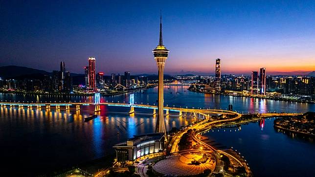 An aerial drone photo taken on July 5, 2024 shows a view of Macao Tower, and Hengqing in Zhuhai City in south China's Guangdong Province. (Photo by Cheong Kam Ka/Xinhua)