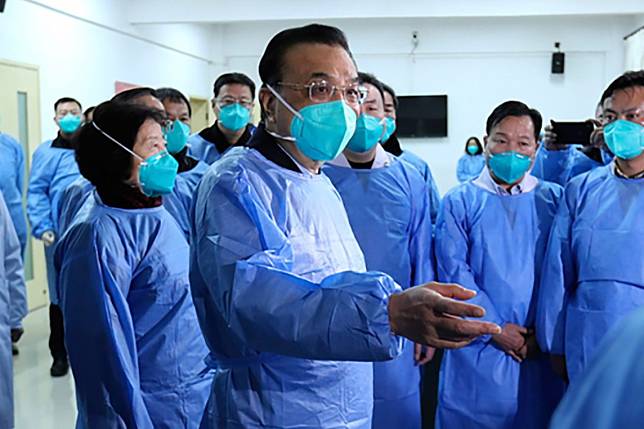 Chinese Premier Li Keqiang (centre) in Wuhan where he is directing the prevention effort against the coronavirus and meeting with patients and medical staff. Photo: Handout