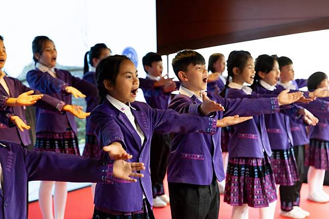 A choir consisting of children of Li and Miao ethnic groups from south China's Hainan Province performs during a Sino-French gastronomy festival aboard a boat along the Seine, in Paris, France, May 4, 2024. (Xinhua/Meng Dingbo)