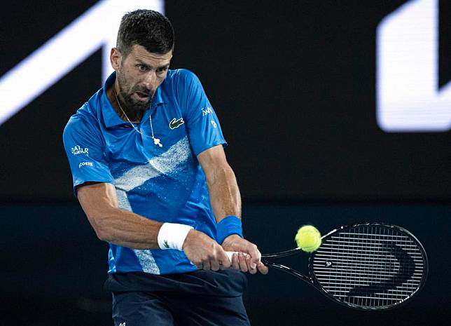 Novak Djokovic of Serbia hits a return during the men's singles quarterfinal against Carlos Alcaraz of Spain at Australian Open tennis tournament in Melbourne, Jan. 21, 2025. (Xinhua/Lui Siu Wai)