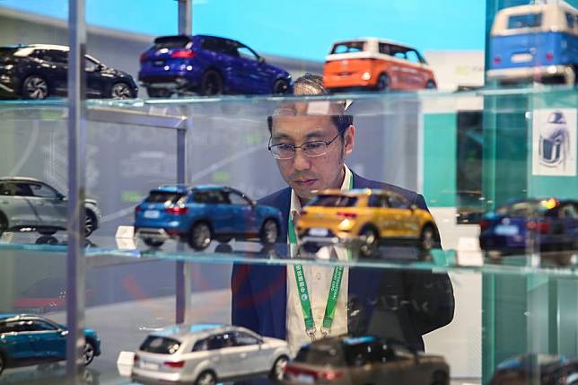 A visitor looks at car models of Volkswagen at the Automobile Exhibition Area during the seventh China International Import Expo (CIIE) in east China's Shanghai, Nov. 7, 2024. (Photo by Chang Nengjia/Xinhua)