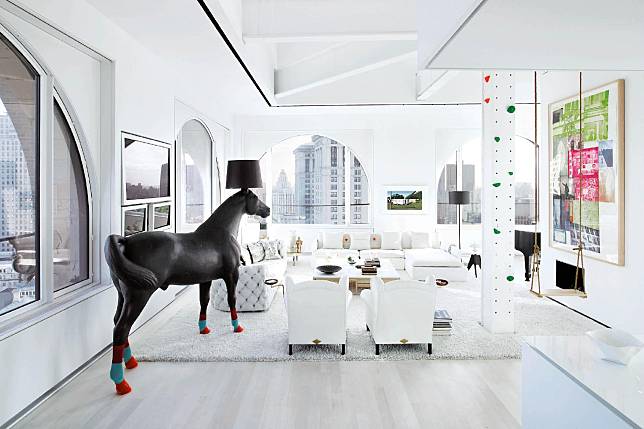 The stark, white walls contrast with pops of bright colour and tongue-in-cheek touches, such as the Horse Lamp designed by Front for Moooi
