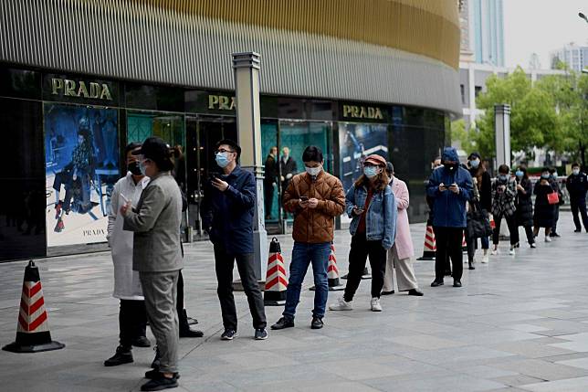 People queue outside a supermarket in Wuhan, the epicentre of the coronavirus outbreak in China. Photo: AFP